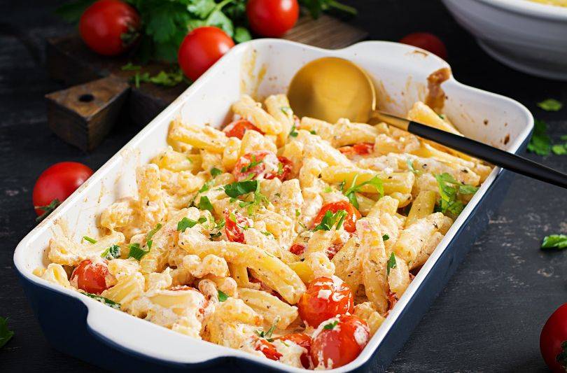 Colorful pasta salad in a glass container inside a refrigerator, illustrating optimal storage for extended shelf life